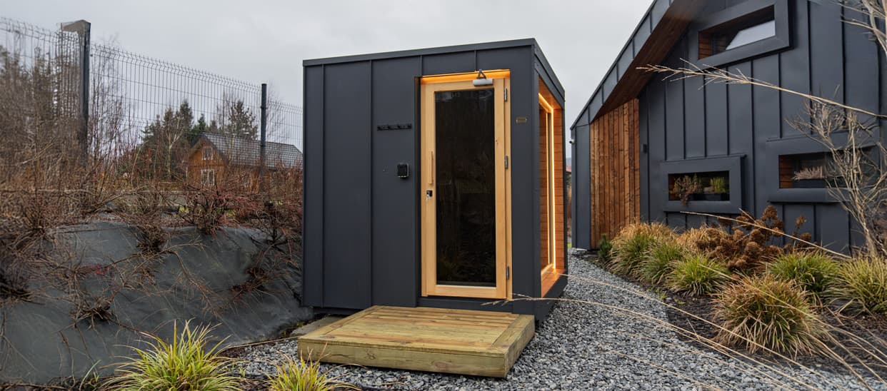 Vetta garden sauna on a gravel bed beside a rocky slope in the Tatras